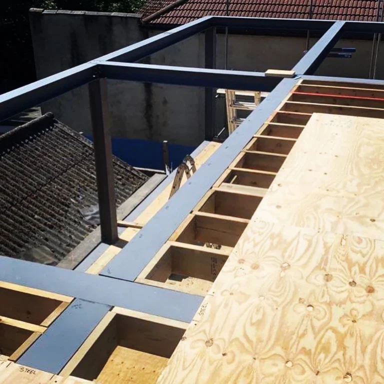 Partial construction of a wooden and metal framework for a building, including extensions, viewed from above. Loft Conversions, House Extensions, Roofing, Bespoke Loft Conversions, House Renovations