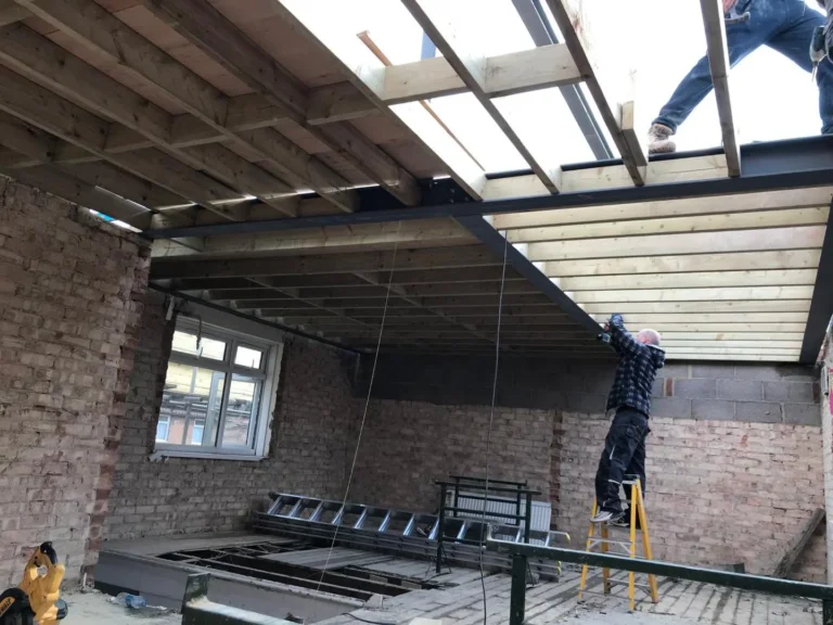 Construction workers are about to install ceiling frameworks in a building under renovation. Loft Conversions, House Extensions, Roofing, Bespoke Loft Conversions, House Renovations
