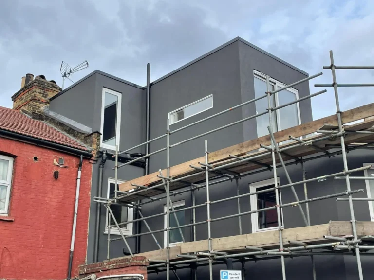 Modern home extensions with scaffolding against a cloudy sky. Loft Conversions, House Extensions, Roofing, Bespoke Loft Conversions, House Renovations